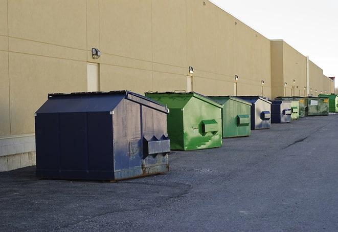 a red construction dumpster placed in front of a building under construction in Danville AL